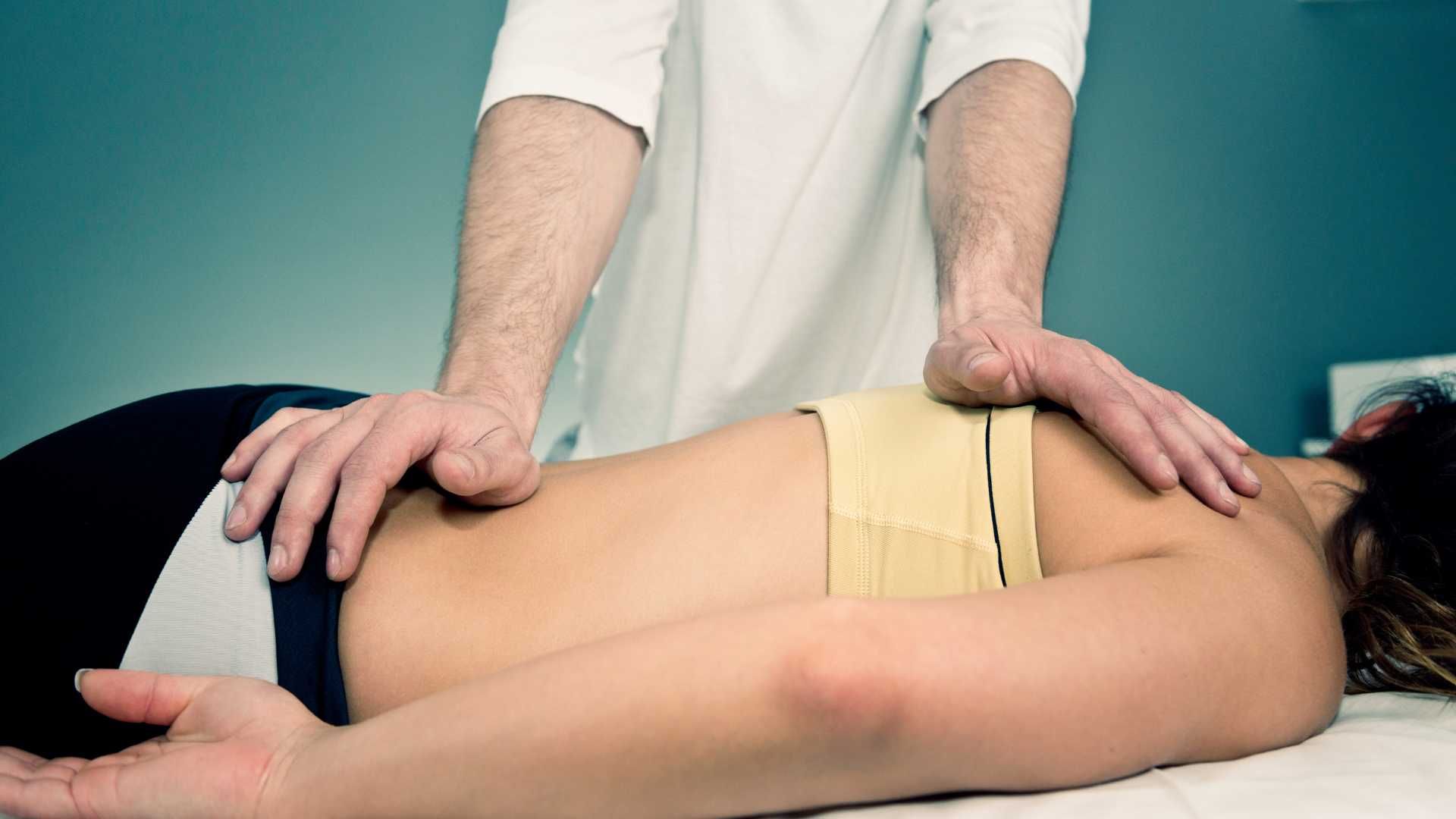 a man is giving a woman a massage on a table .