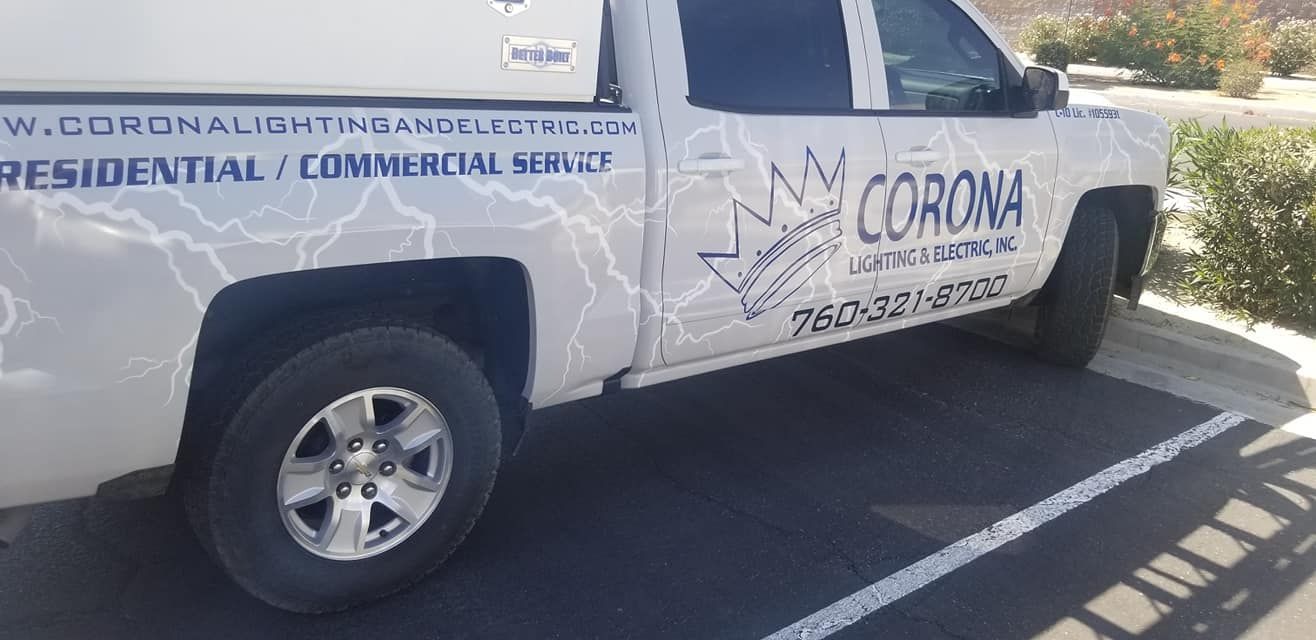A white truck with the word corona on the side is parked in a parking lot.