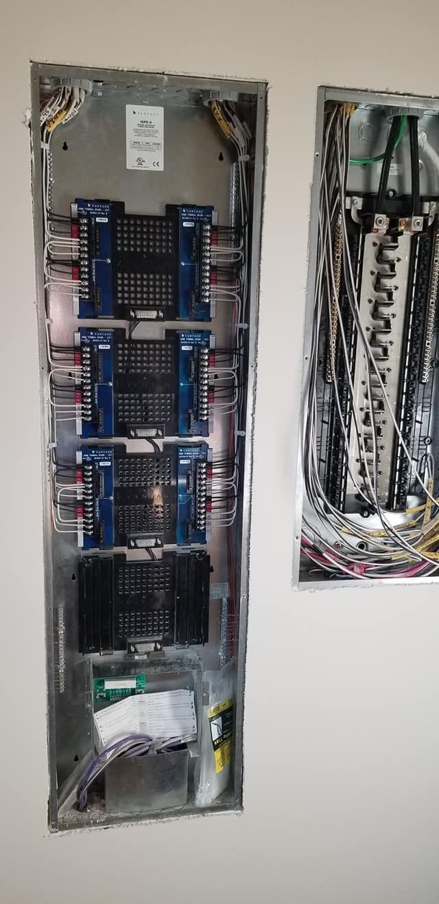 Two electrical panels are hanging on a wall.
