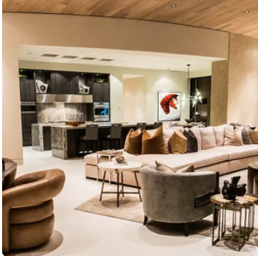 A living room with a large couch and chairs