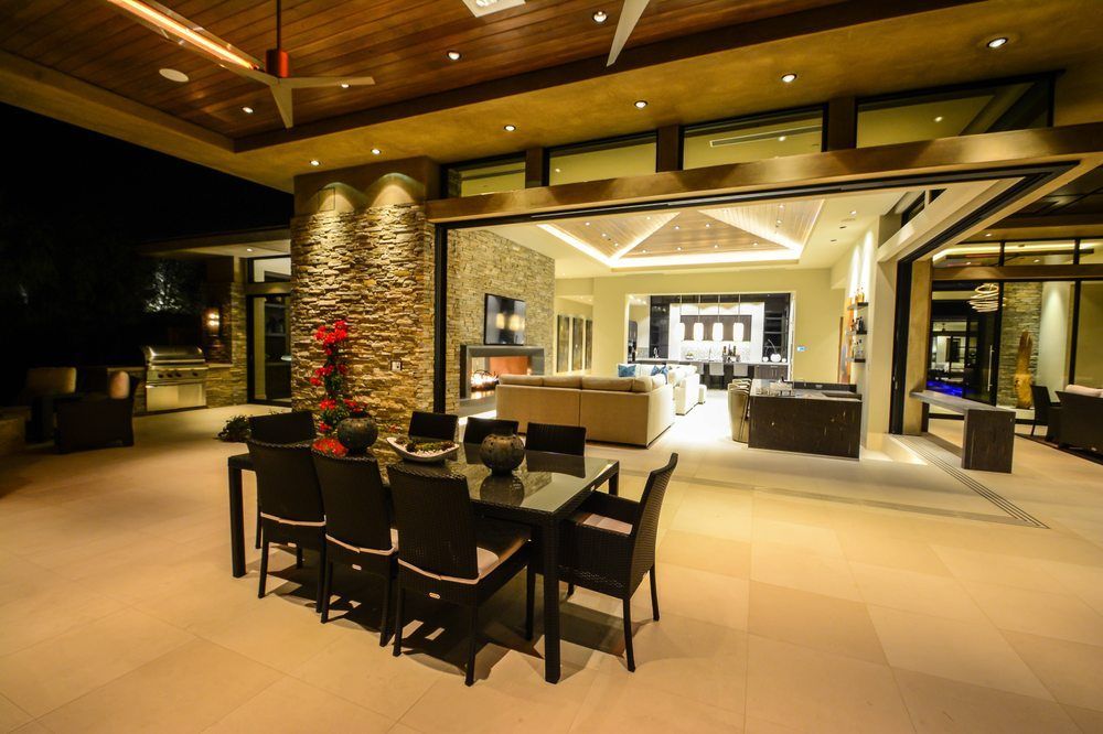 There is a dining table and chairs in the middle of the room.