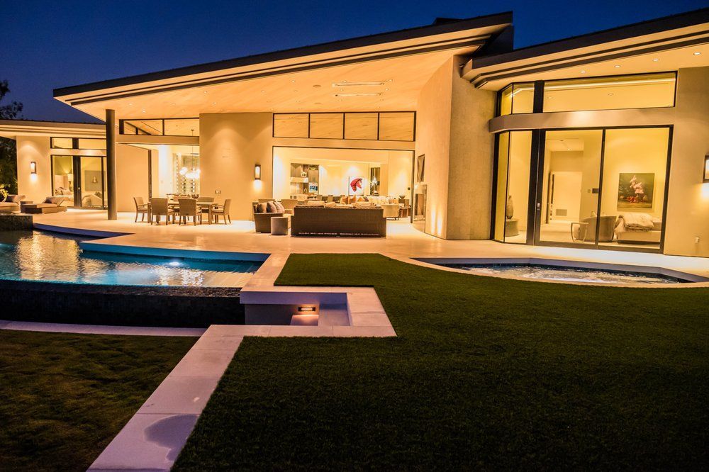 A large house with a swimming pool in the backyard