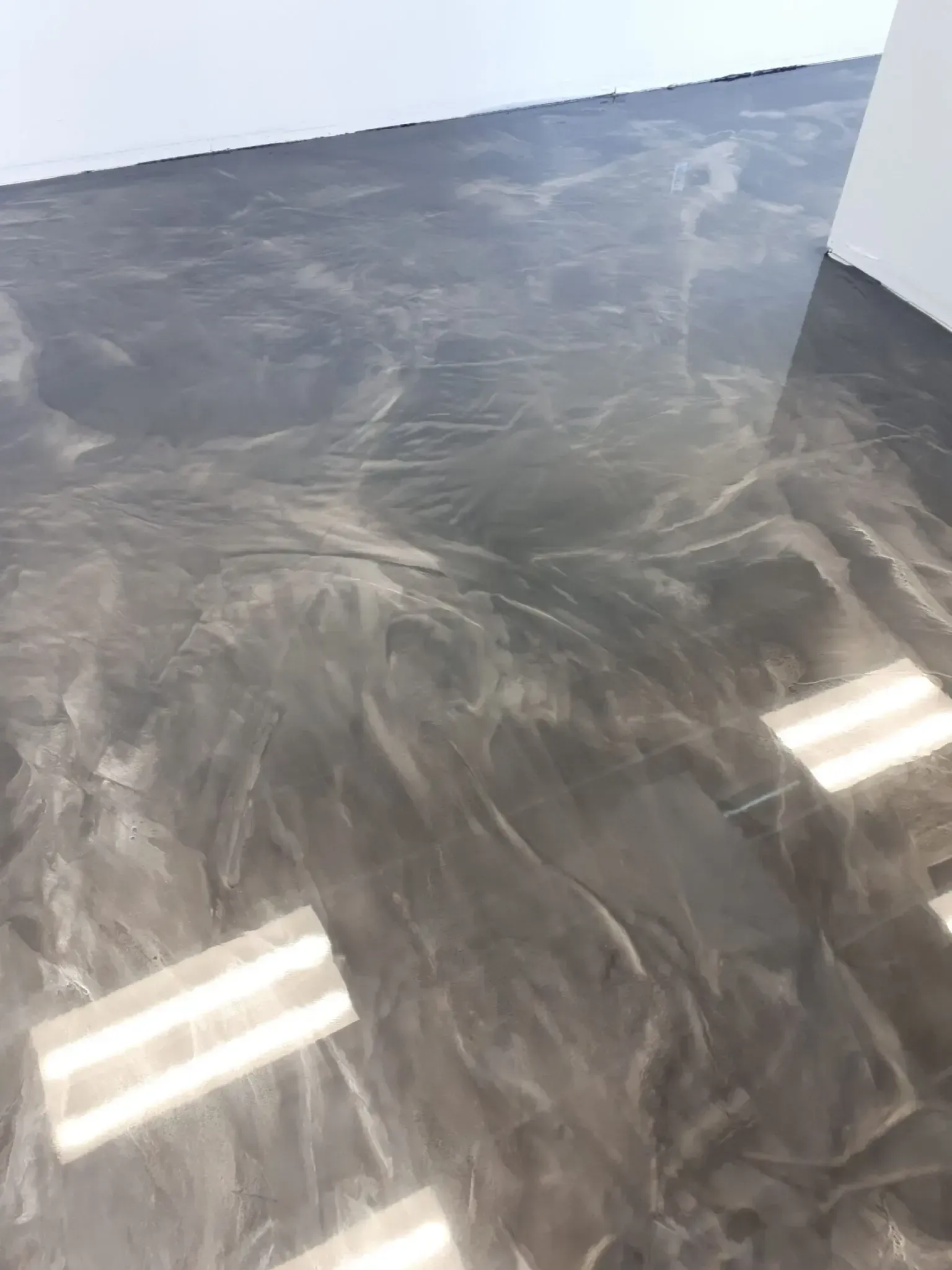 A close up of a shiny metallic floor in a room.