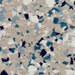 A close up of a marble floor with blue , white and black chips.