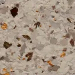 A close up of a white and brown granite counter top.