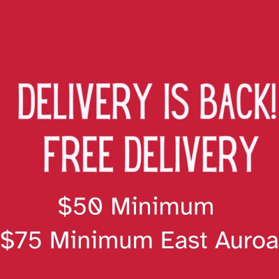 Red sign reading “Delivery is Back! Free Delivery,” with $50 minimum and $75 minimum east Aurora.