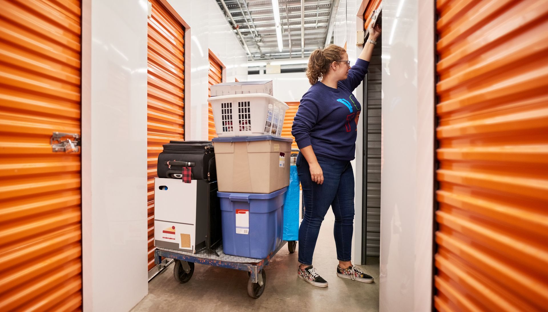 Woman storing her belongings in an Allsafe Self Storage unit, highlighting convenient storage solutions in Knoxville, TN. Woman storing her belongings in an Allsafe Self Storage unit, highlighting convenient storage solutions in Knoxville, TN.