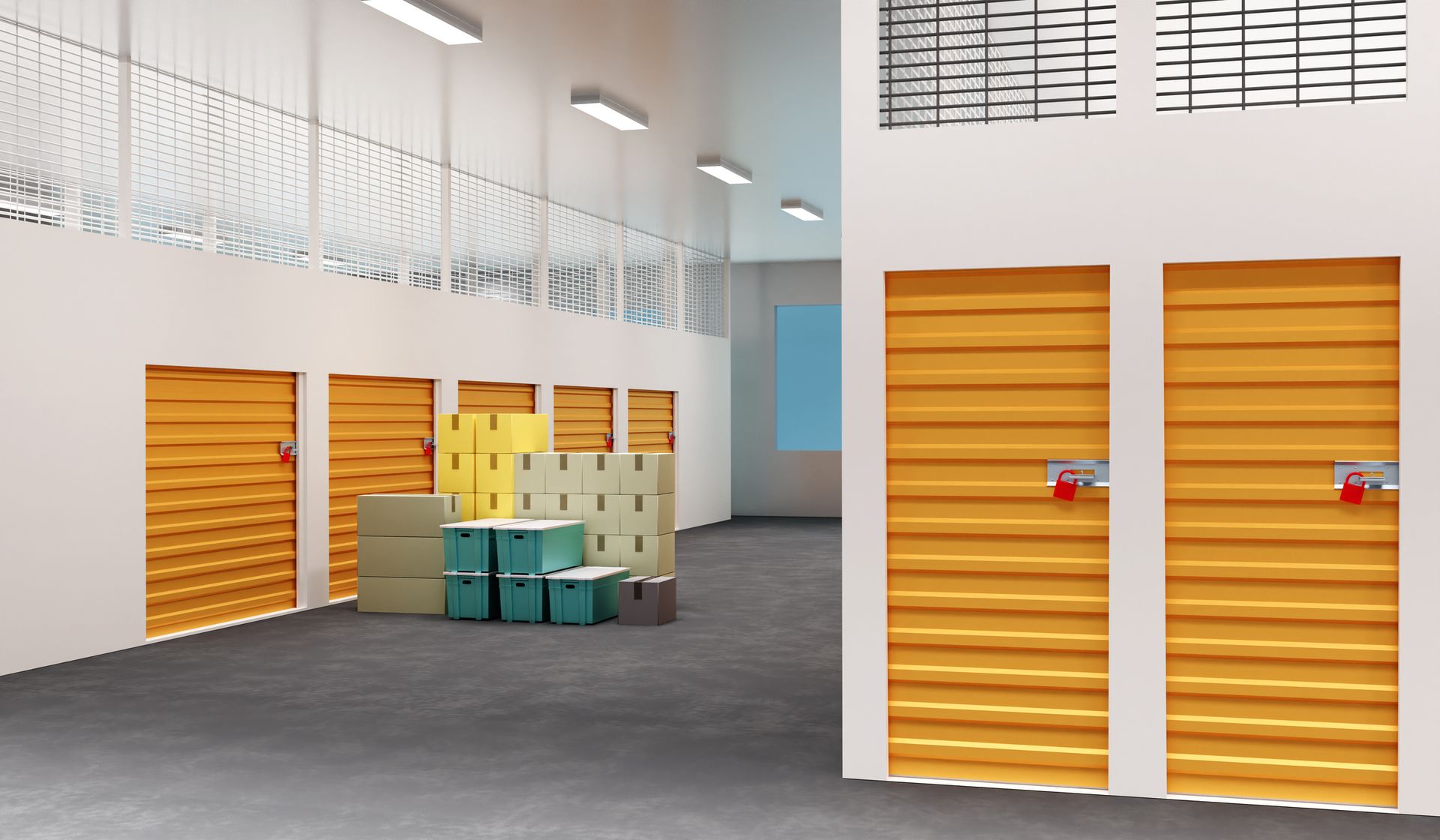 Interior of a storage facility with several units; wooden doors, boxes, and a concrete floor.