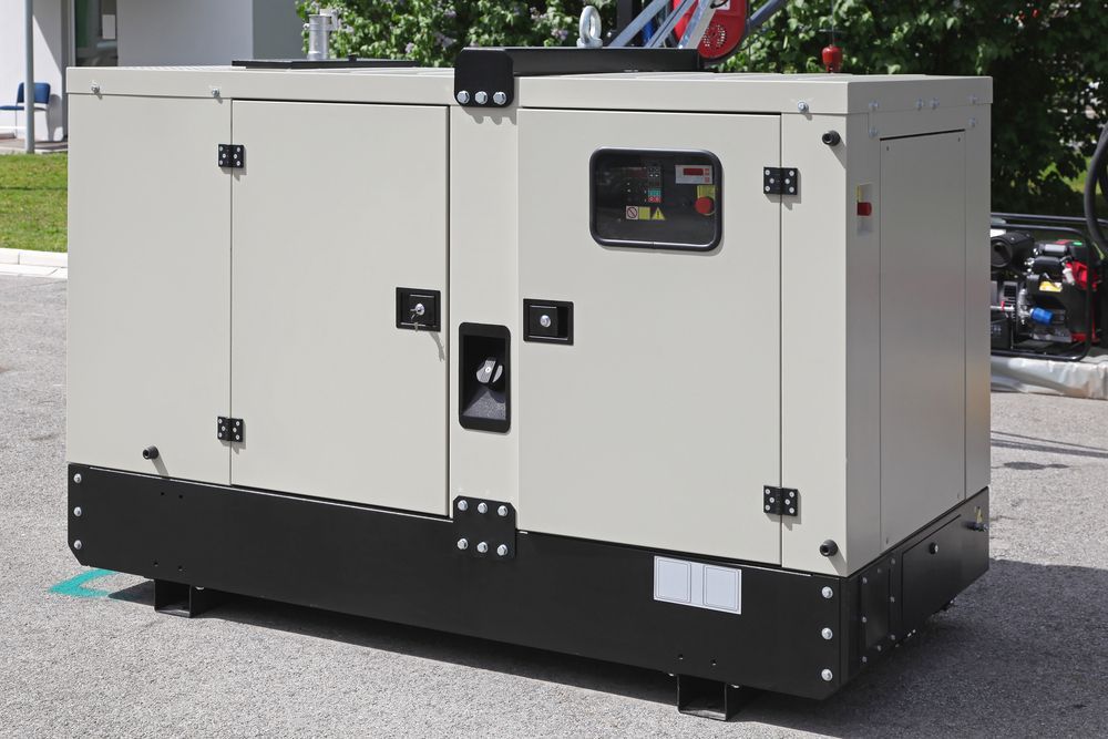A Beige Industrial Generator With Black Trim, Parked Outside on Concrete — Waite Diesel Service in Douglas, QLD