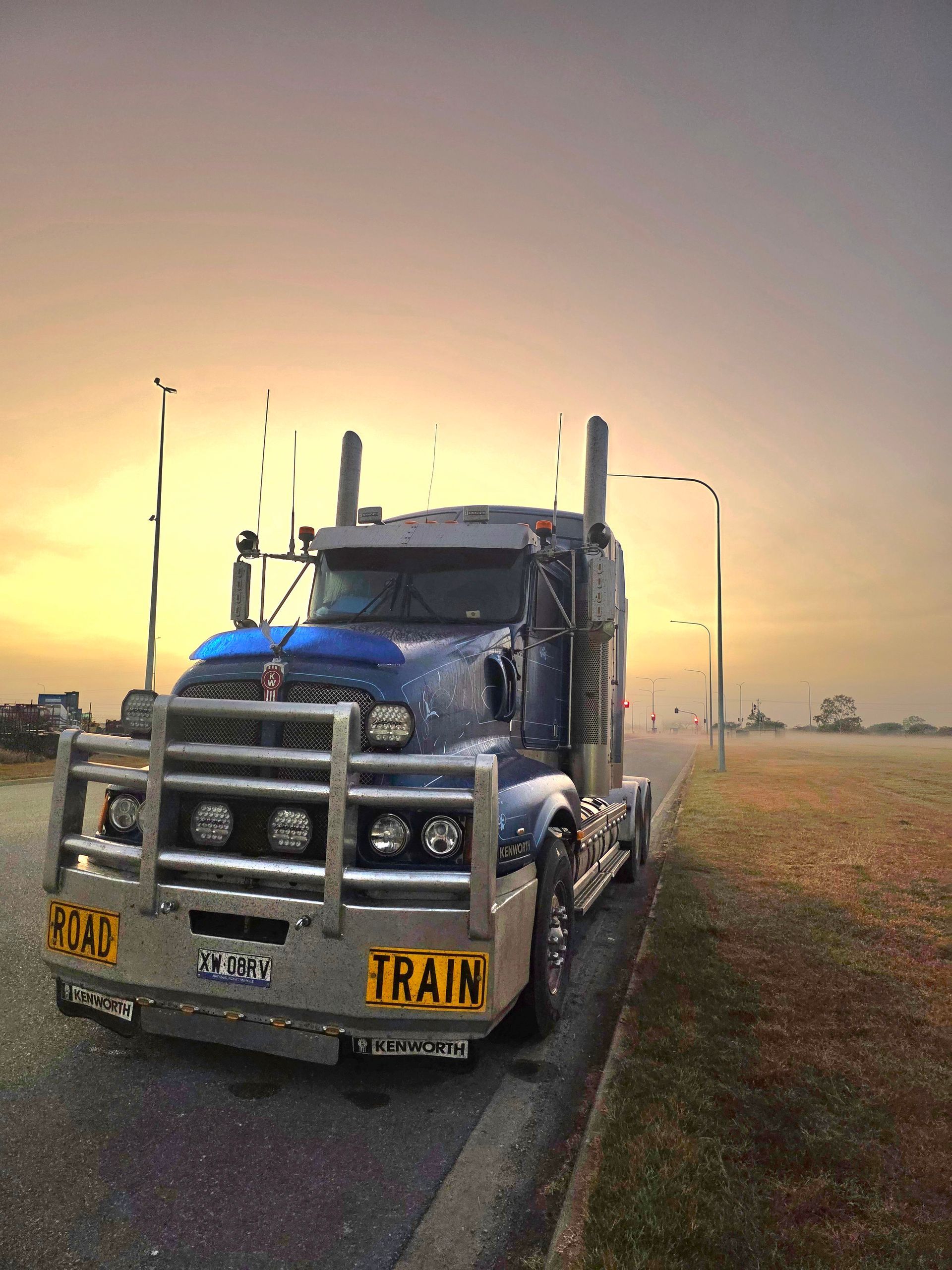 Yellow Dump Truck Dumping Soil on a Rocky Construction Site — Waite Diesel Service in Douglas, QLD