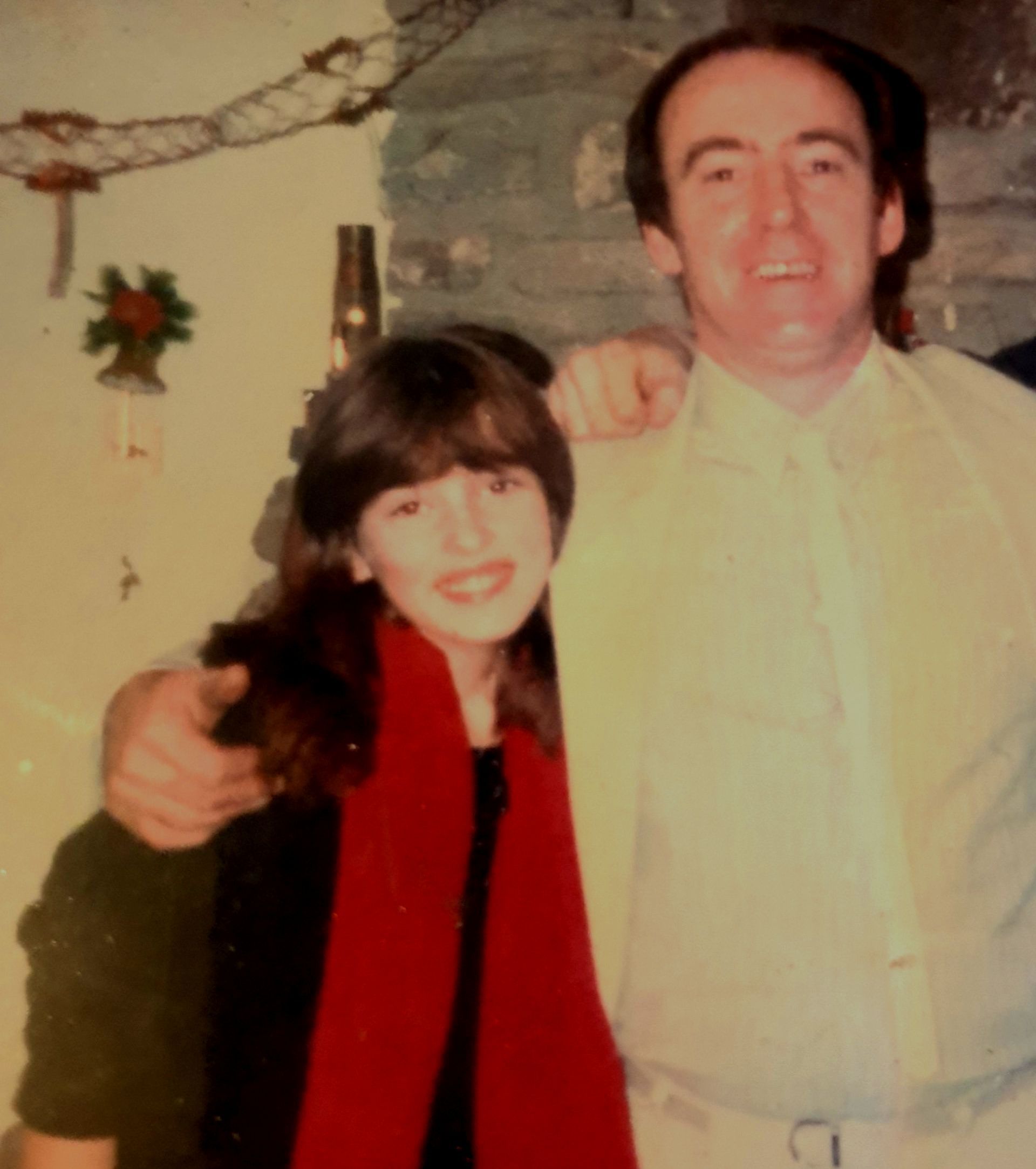 A teenage girl standing next to her father.