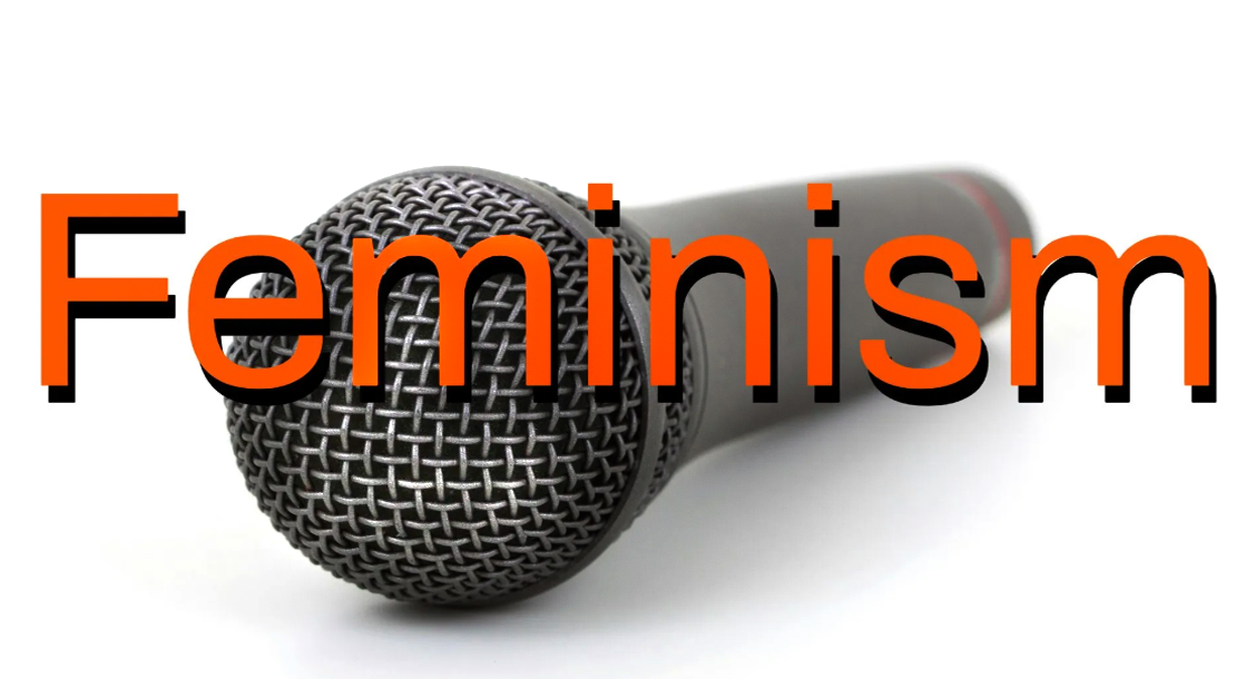 A microphone on a white background behind the word 'Feminism'.