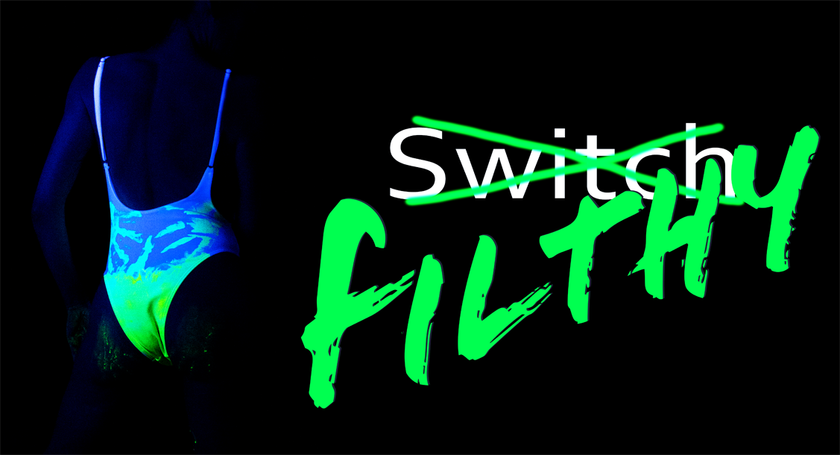 A woman in a white swimsuit covered in neon green paint with the word 'Switch' crossed out and 'Filthy' written across it. 