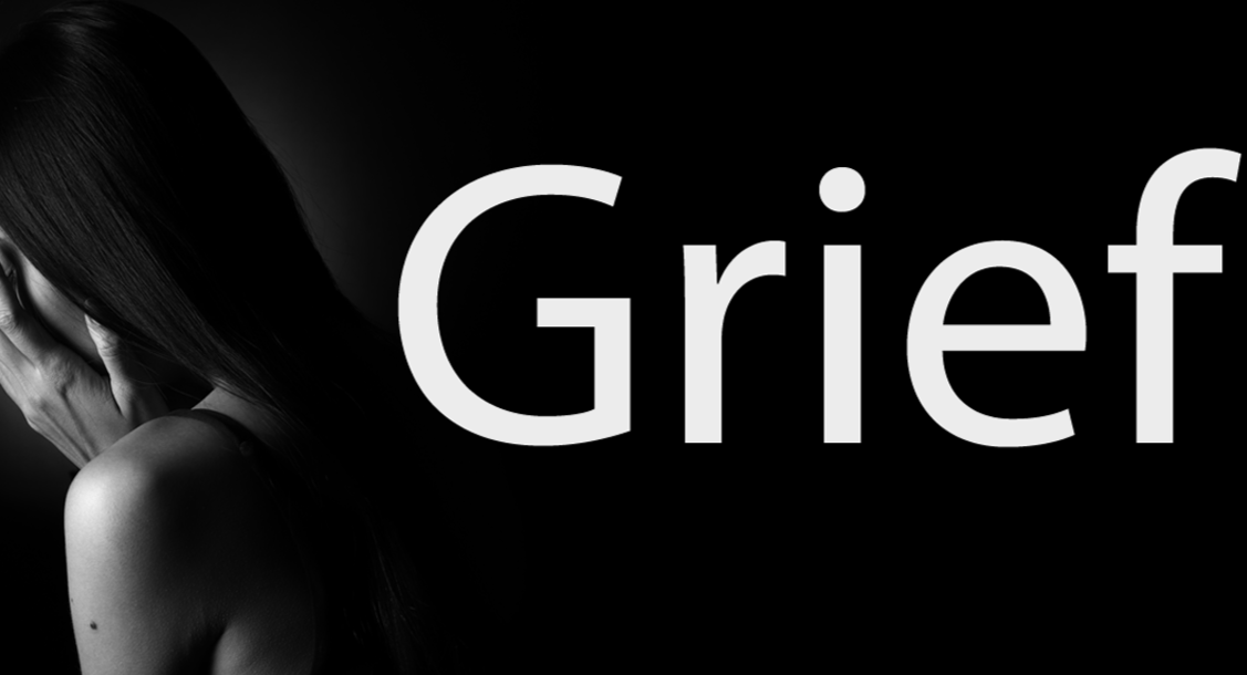 Black and white image of a woman covering her face on a black background with the word 'Grief', in white, next to it.