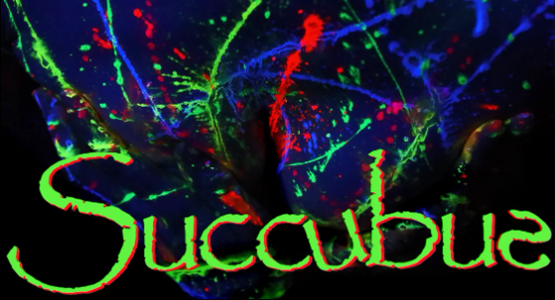 Woman's hands covering her breast, splattered in neon UV pain and 'Succubus' written across the image.