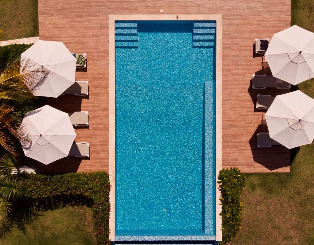 Overhead View of a Rectangular Pool With Blue Tile Surrounded — East Coast Pool Resurfacing In Brisbane, QLD