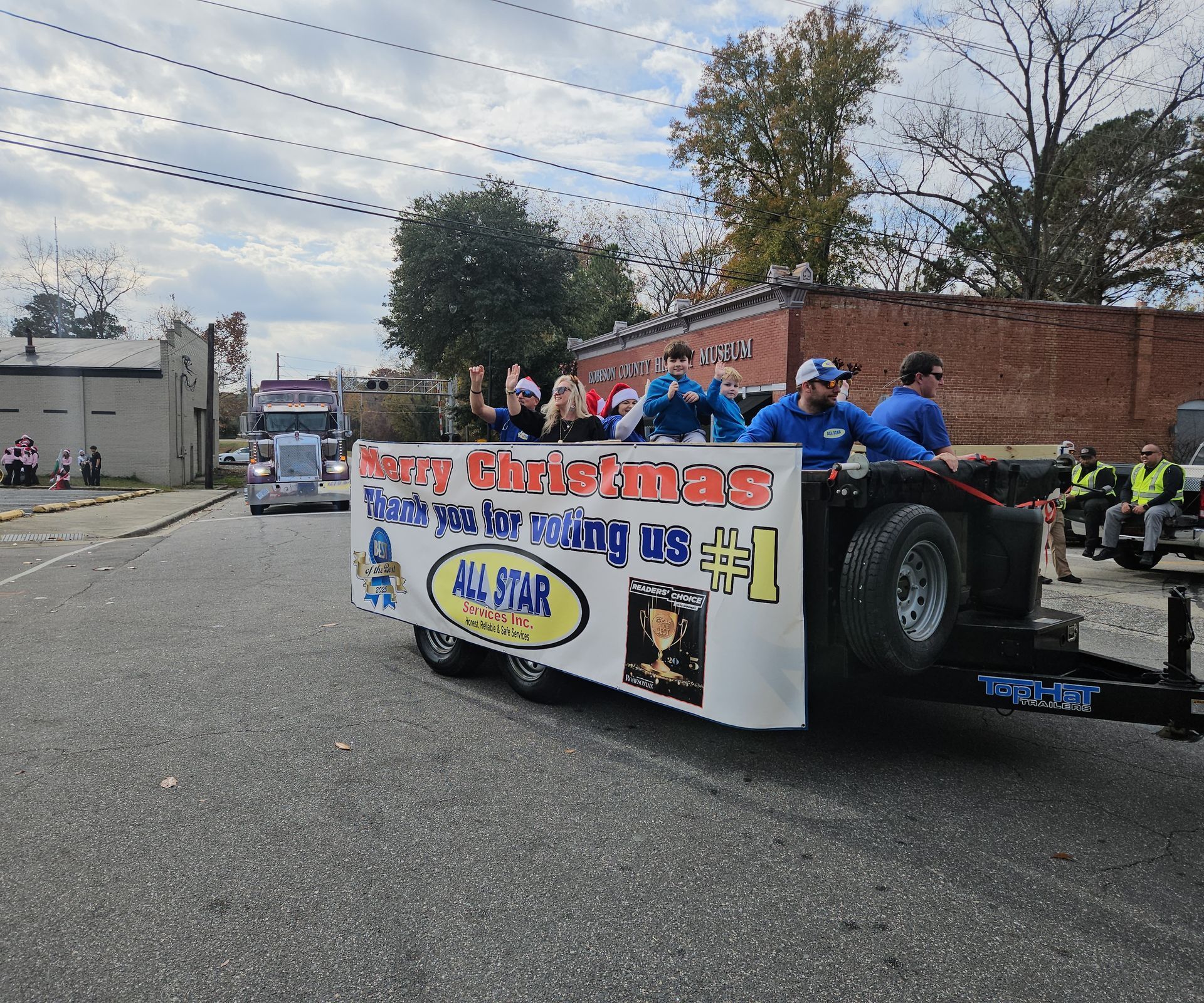 A float in a parade with a banner reading
