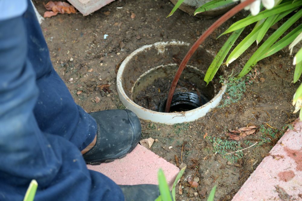 Person Unclogging a Drain With a Snake Tool — HFB Plumbing & Gas in Wrights Creek, QLD