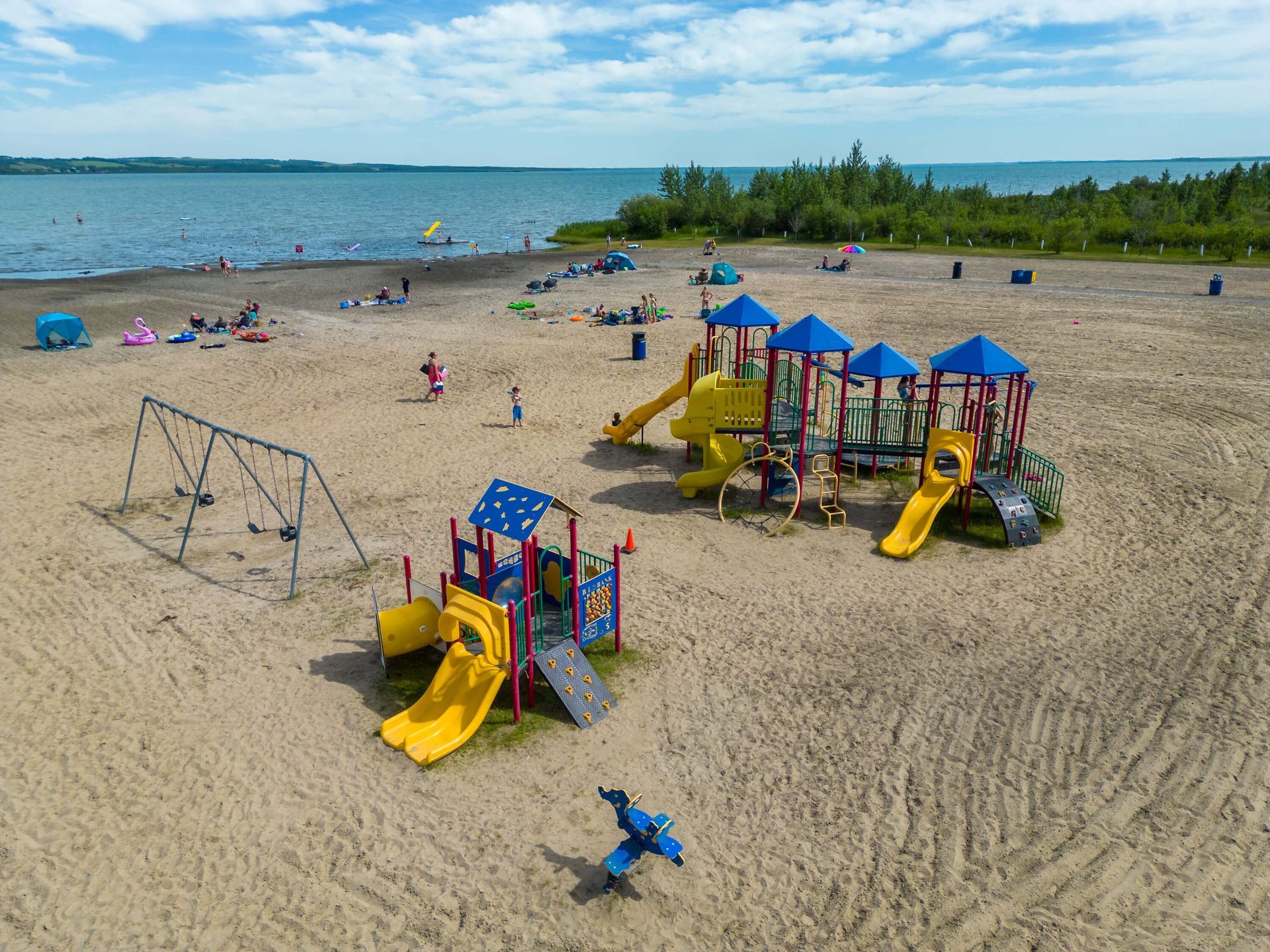 An aerial view of a playground on a sandy beach.