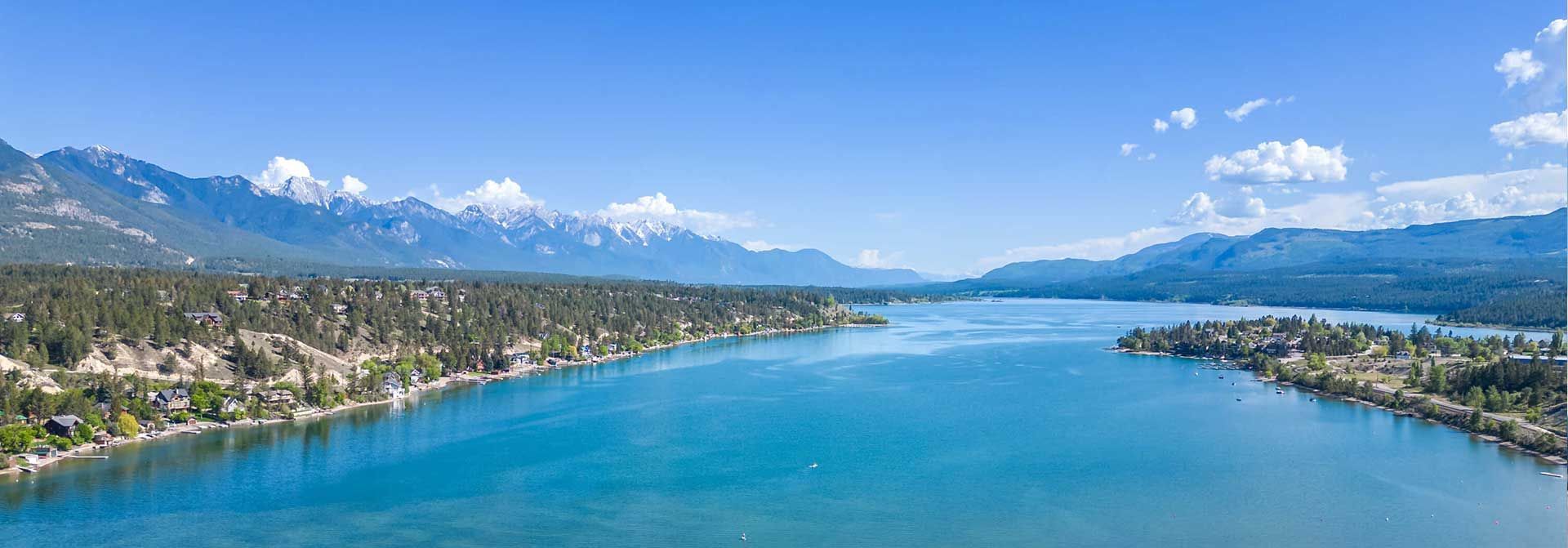 An aerial view of a lake with mountains in the background.