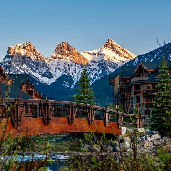 A bridge over a river with mountains in the background