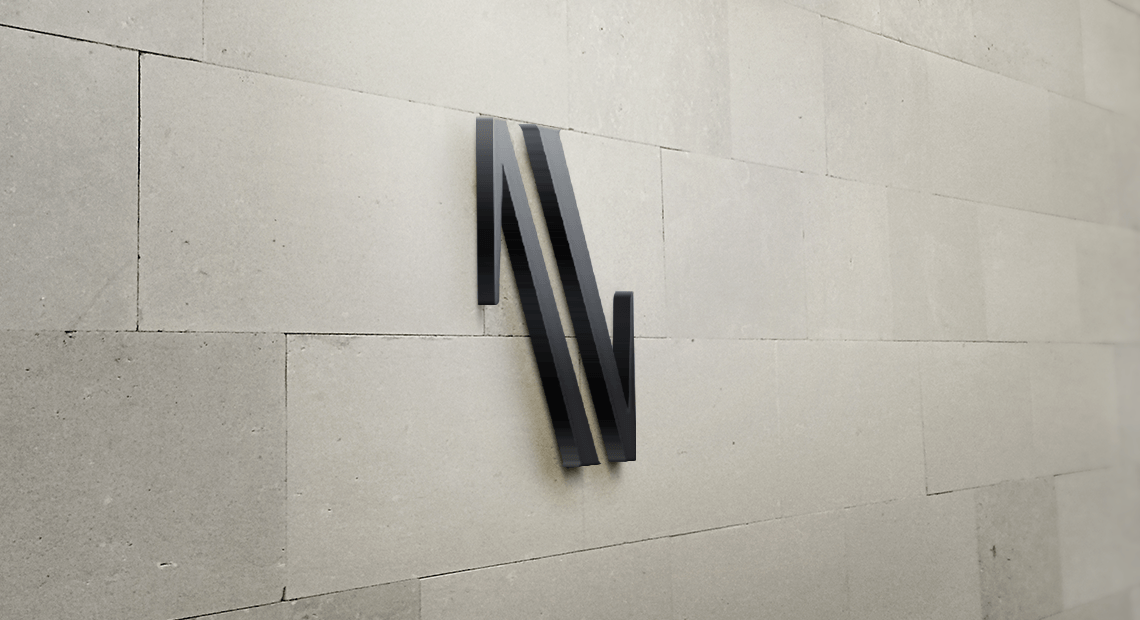A black letter n is on a white wall.