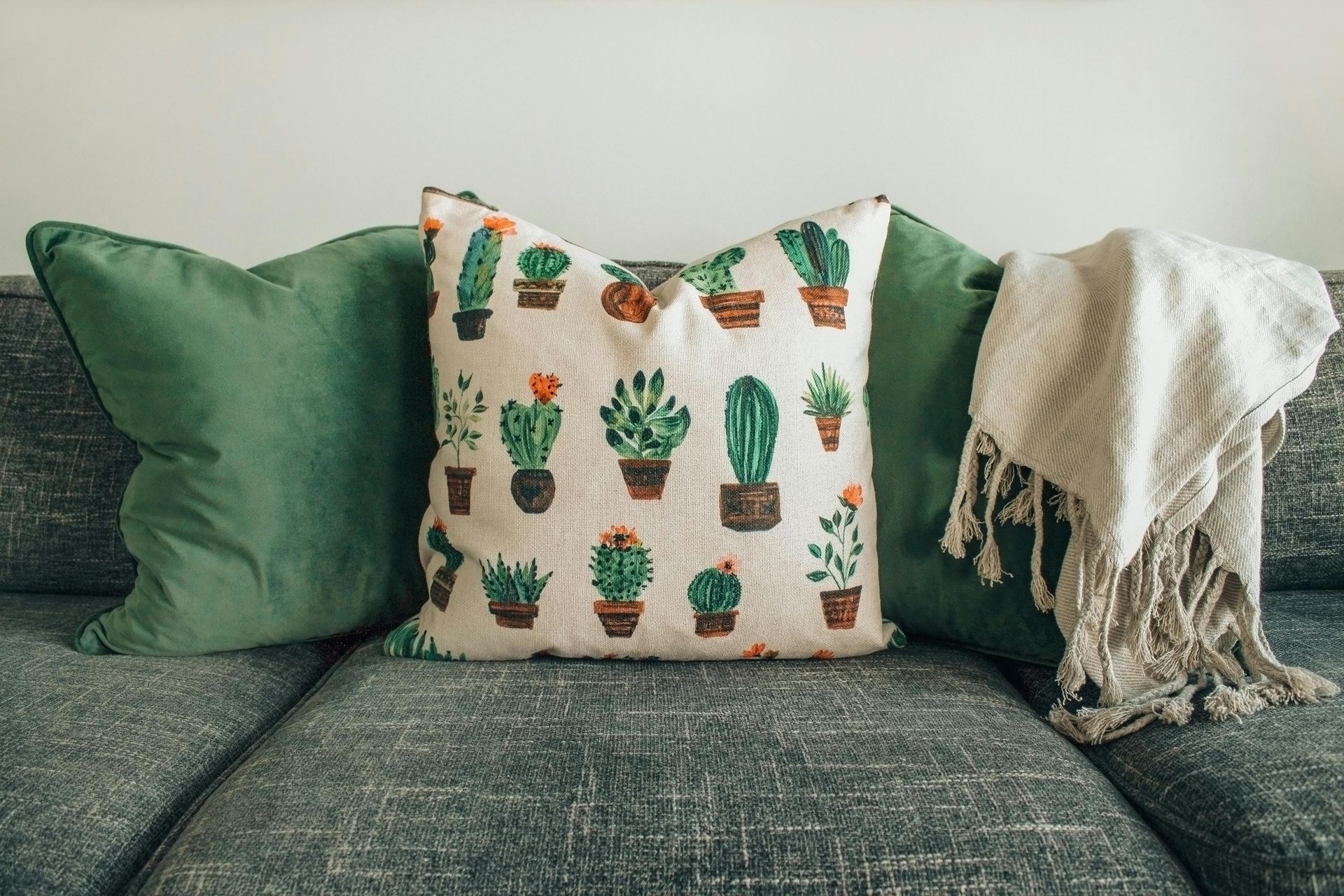 A living room with a couch , chair , coffee table and rug.