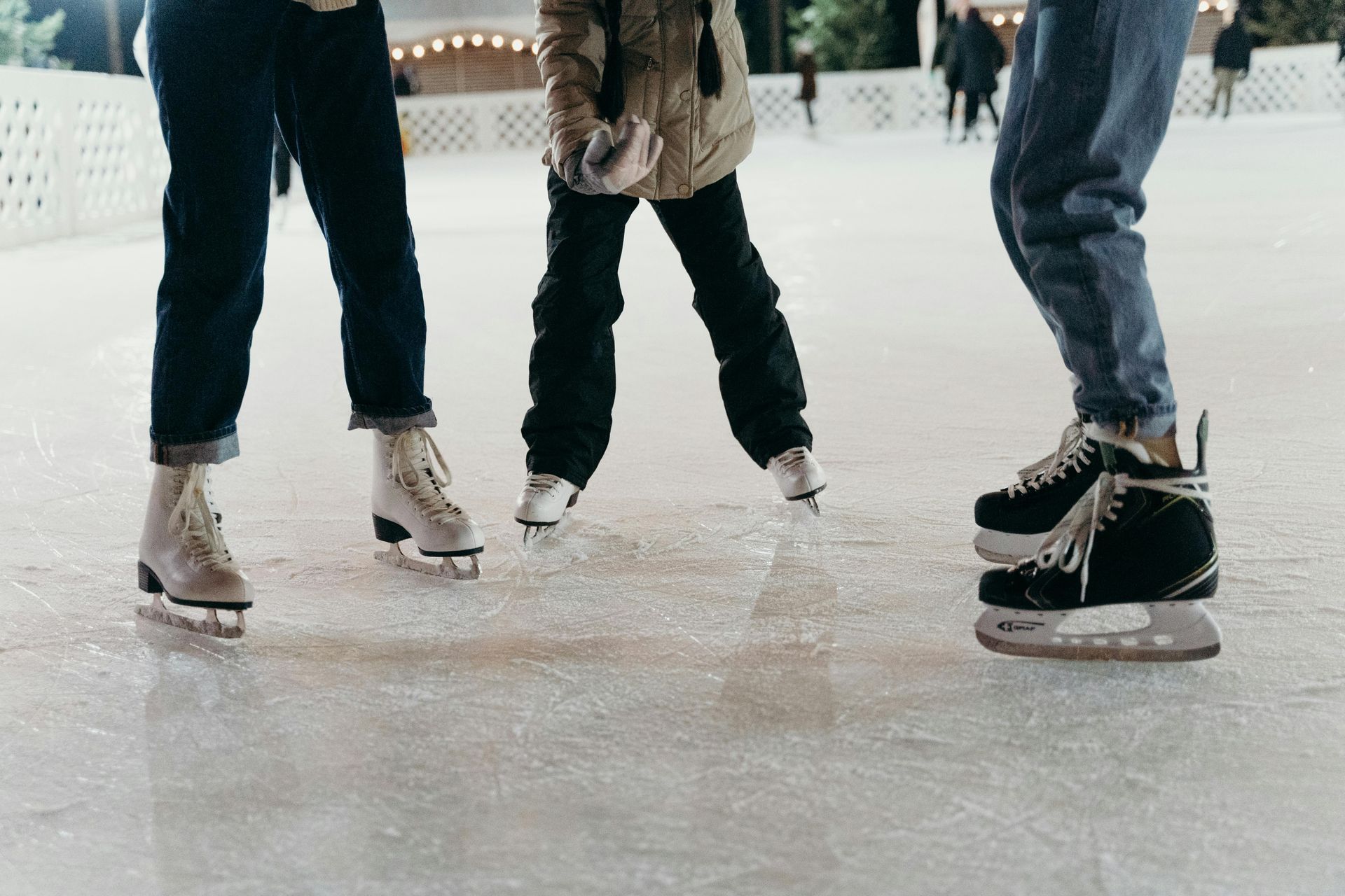 People ice skating outdoors.