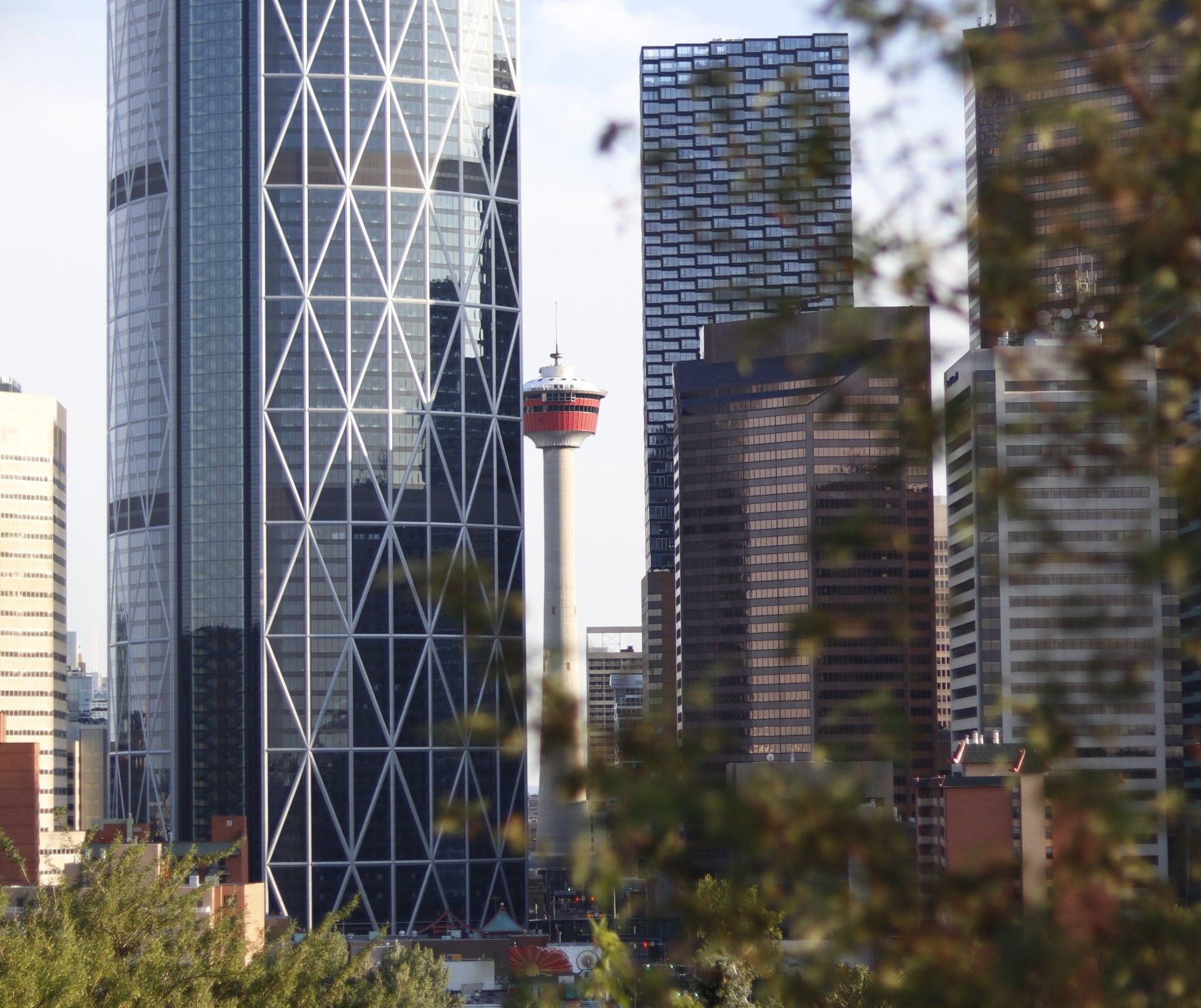 A city skyline with a tall building that has the word rock on it