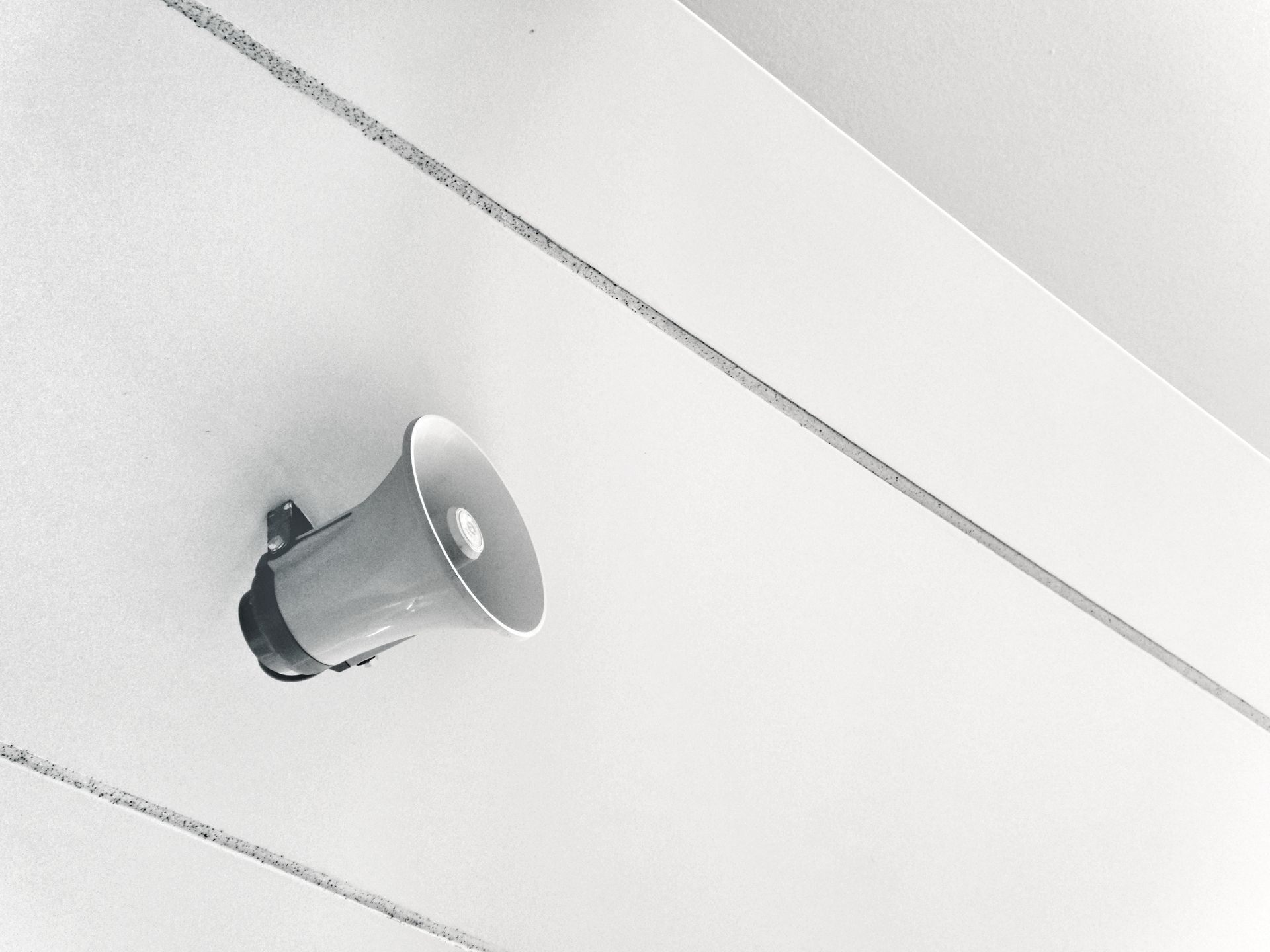 A megaphone is hanging from the ceiling of a building