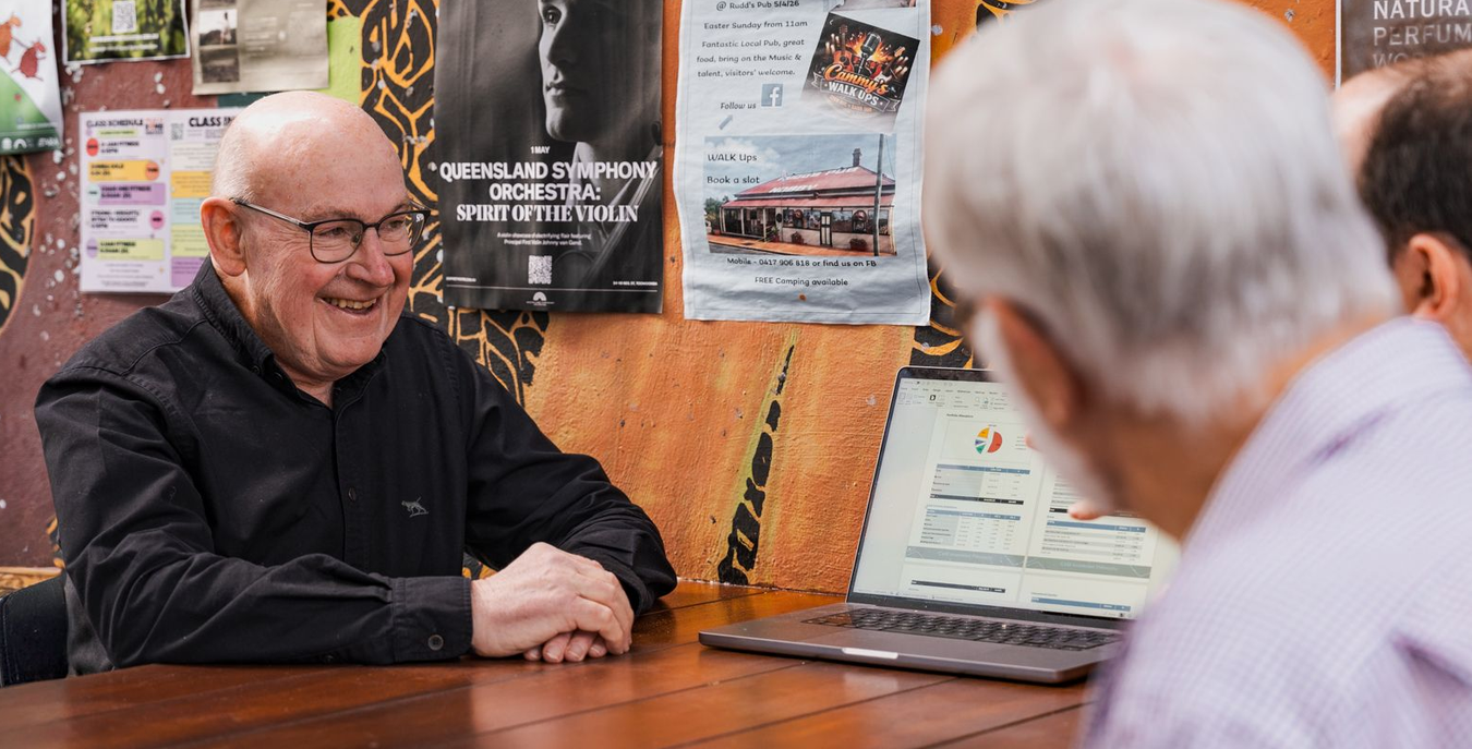 Man showing financial report to clients on a computer