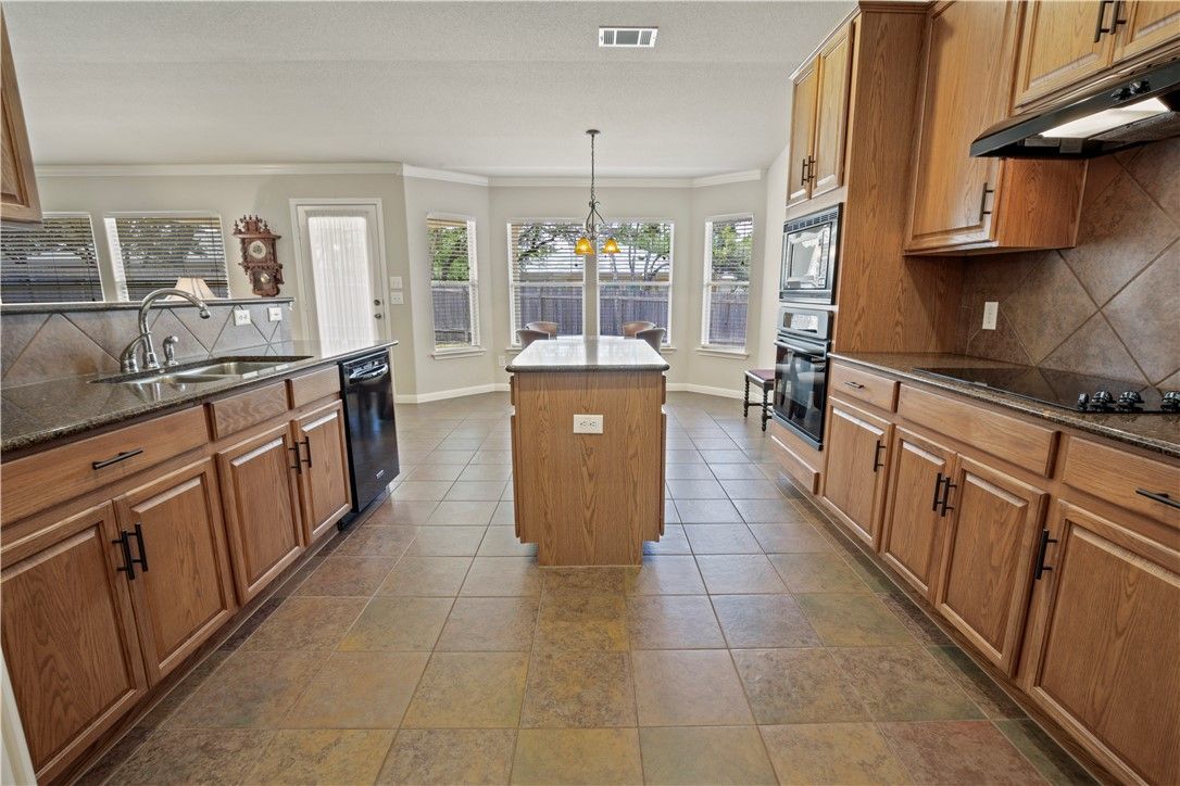 A kitchen with a large island in the middle of it.