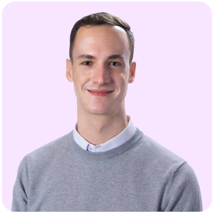 Portrait of a smiling person in a gray sweater against a light lavender background
