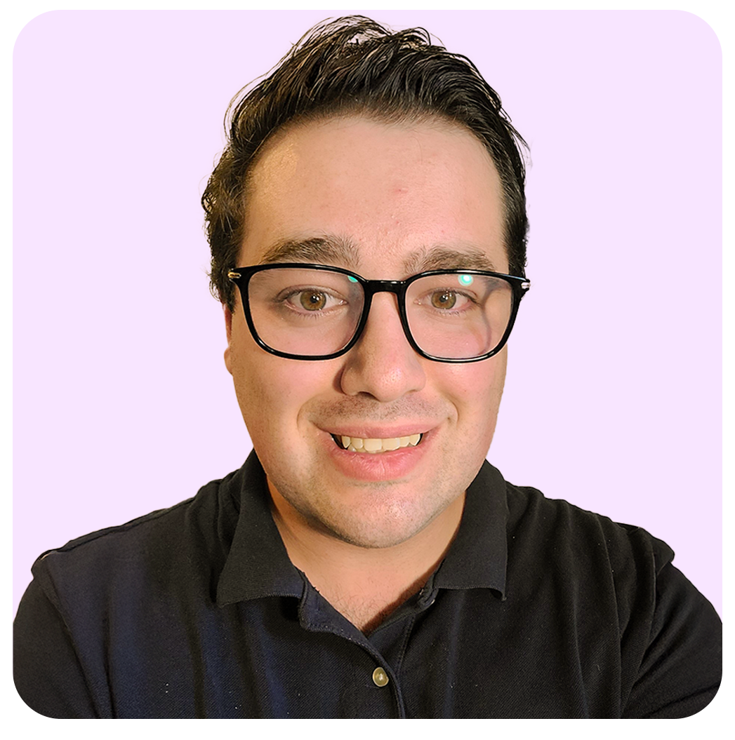 Smiling person with glasses in a black shirt against a light purple background