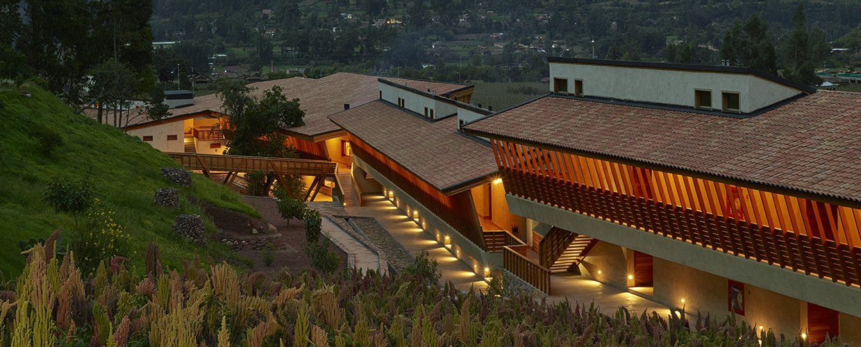 Un gran edificio con balcón está situado en la cima de una colina.