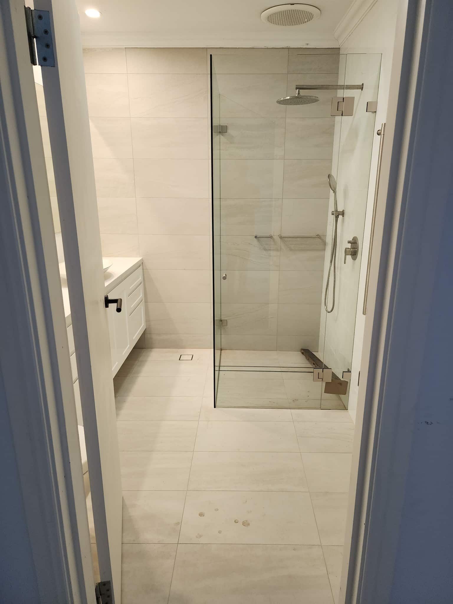 A Bathroom With A Walk In Shower And A Sink — Renovate A Space In Gosford, NSW