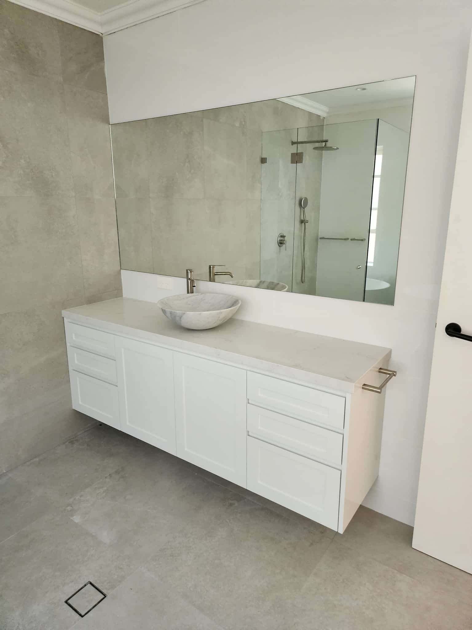 A Bathroom With A Sink And A Large Mirror — Renovate A Space In Toukley, NSW