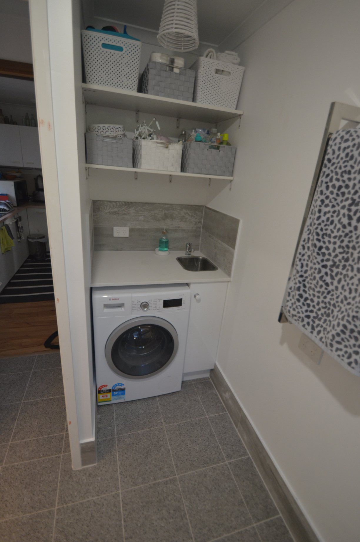 A Laundry Room With A Washer And Dryer And A Sink — Renovate A Space In Empire Bay, NSW