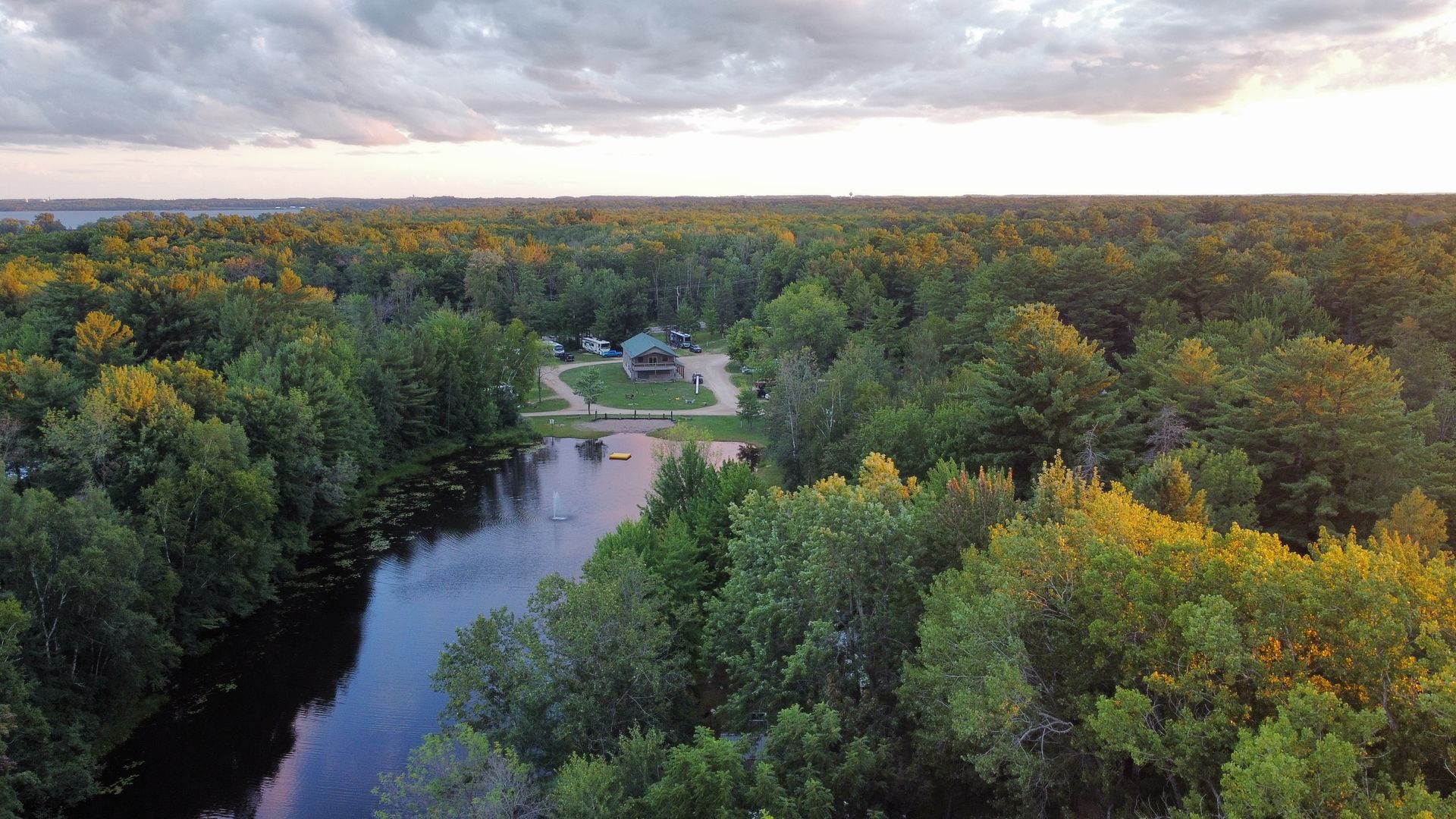 An aerial view of a lake surrounded by trees in Shawano Wisconsin