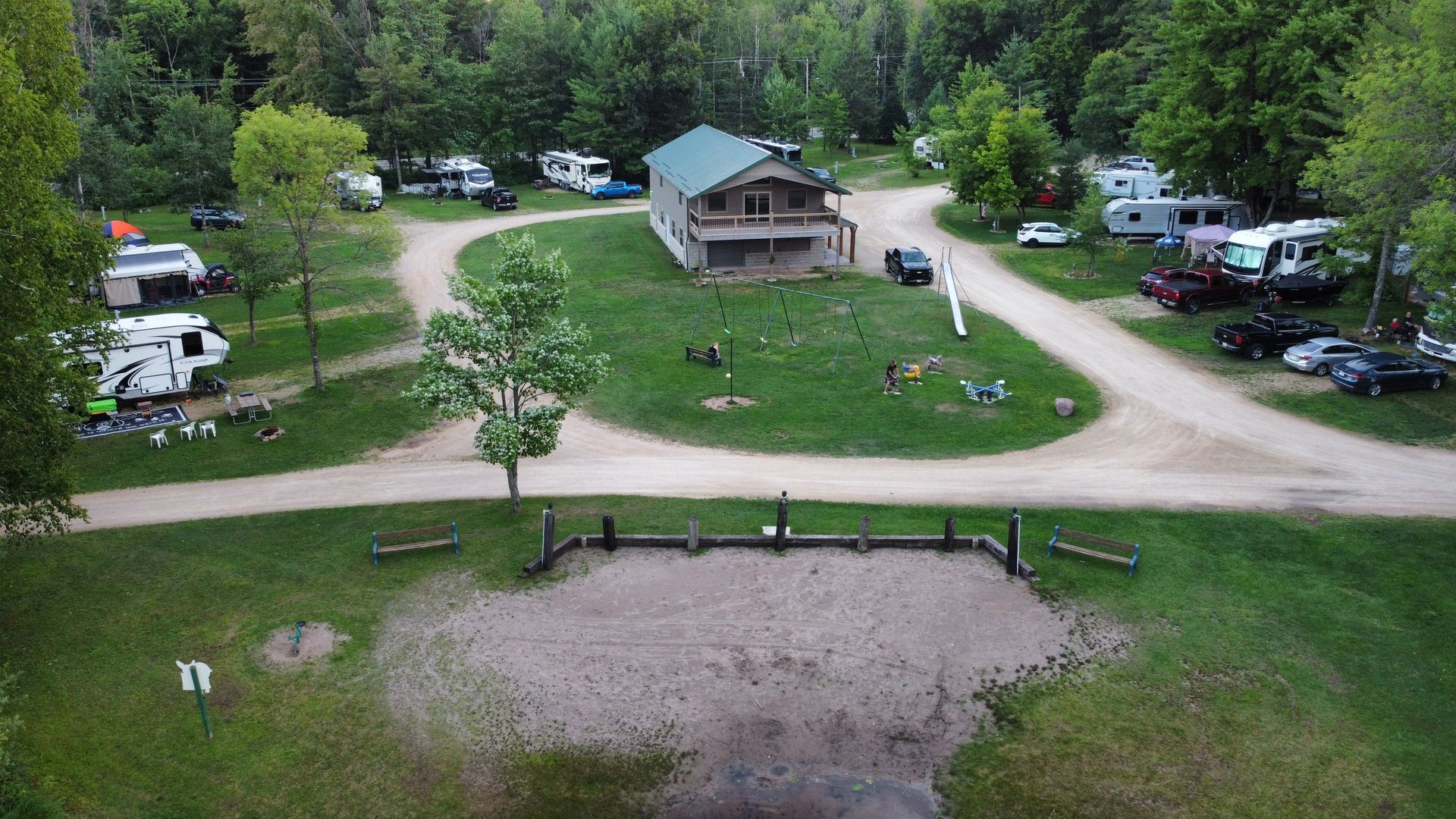 An aerial view of fawn lake campground filled with rvs and a house.