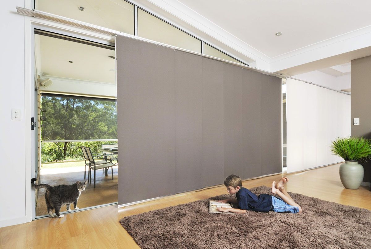 window coverings in living room with a child reading - Maxview Blinds & Shutters