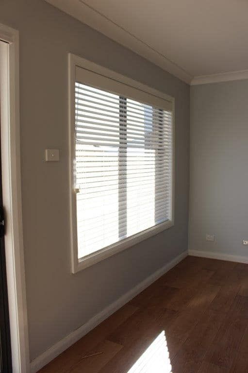 An Empty Room With A Large Window And Blinds — Maxview Blinds and Shutters in Beresfield, NSW