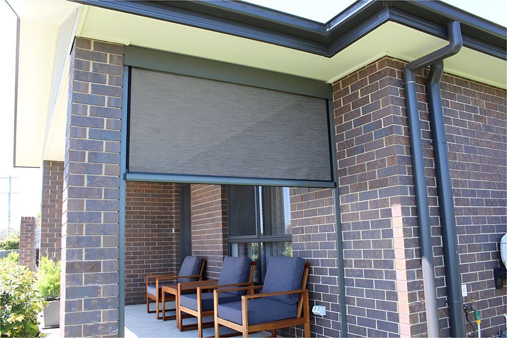 A Covered Patio With Gray Ziptrak Blinds — Maxview Blinds and Shutters in Beresfield, NSW