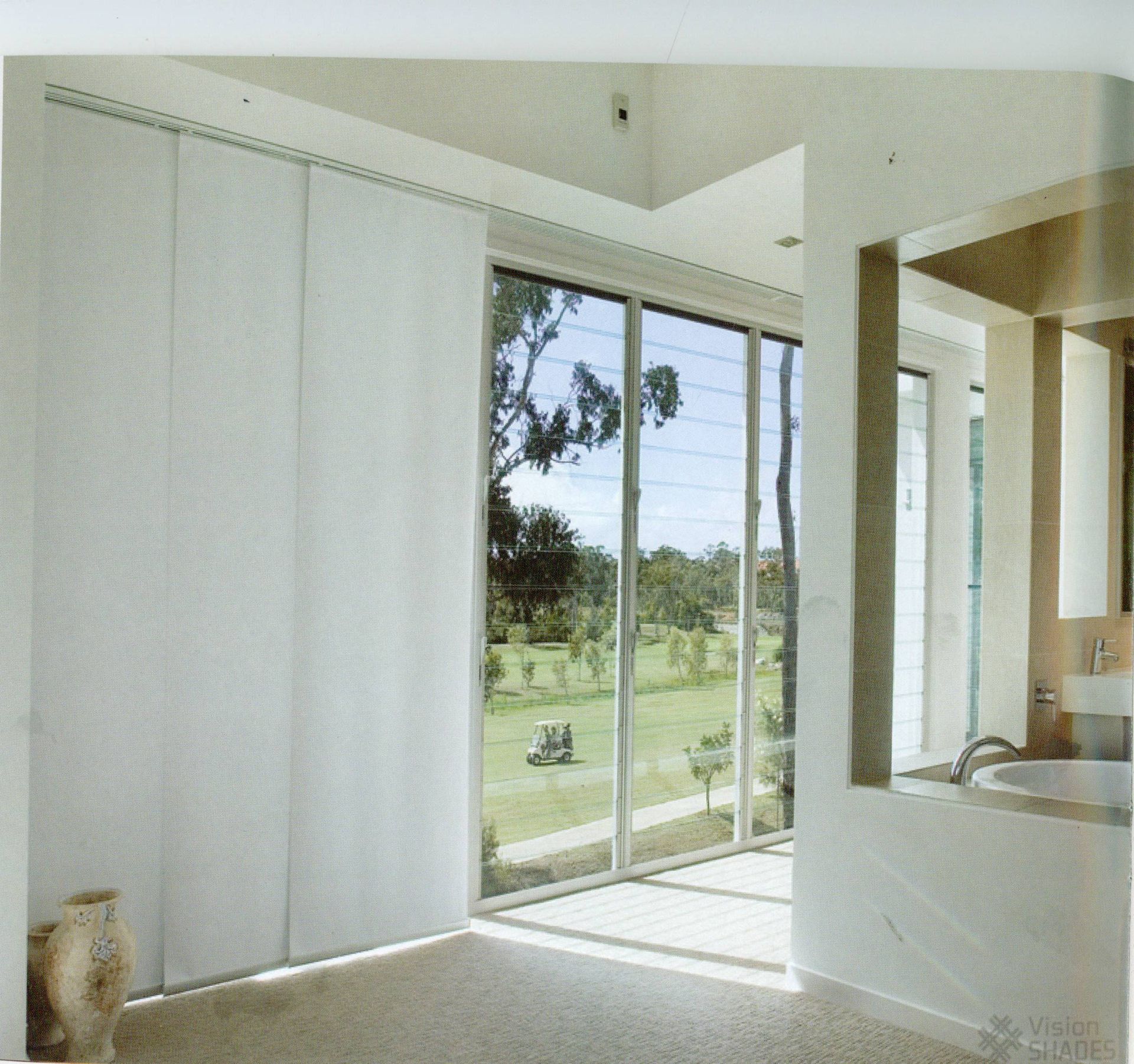 window with coverings overlooking greenery with a golf cart - Maxview Blinds & Shutters