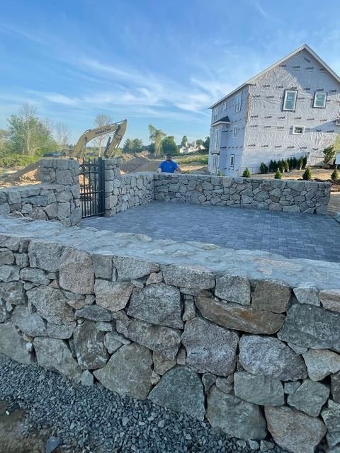 A large swimming pool is being built in a backyard.