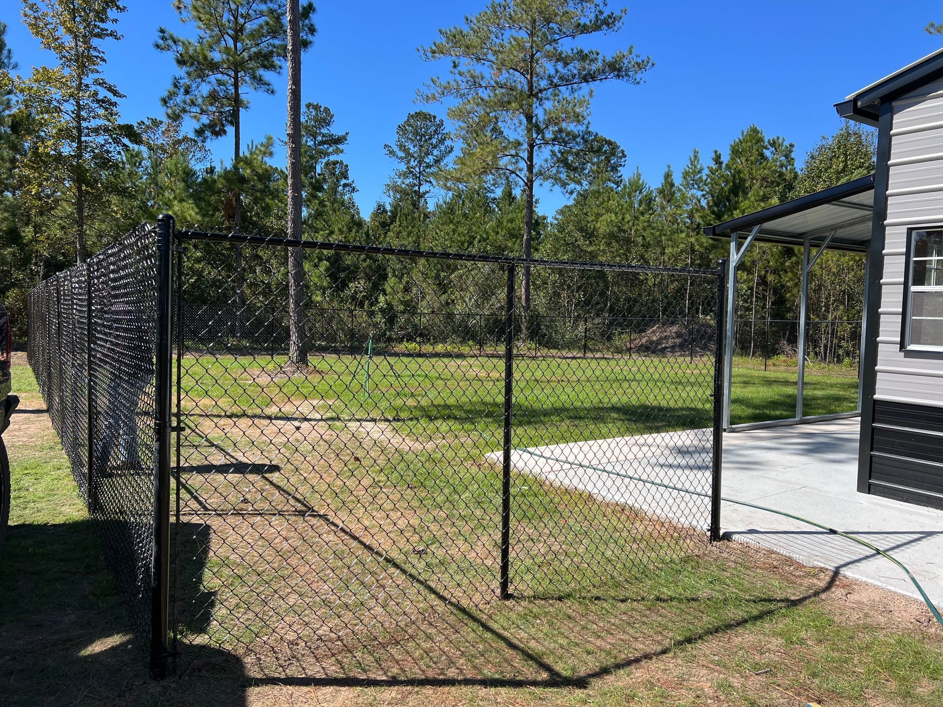 A close up of a chain link fence with a blurred background.