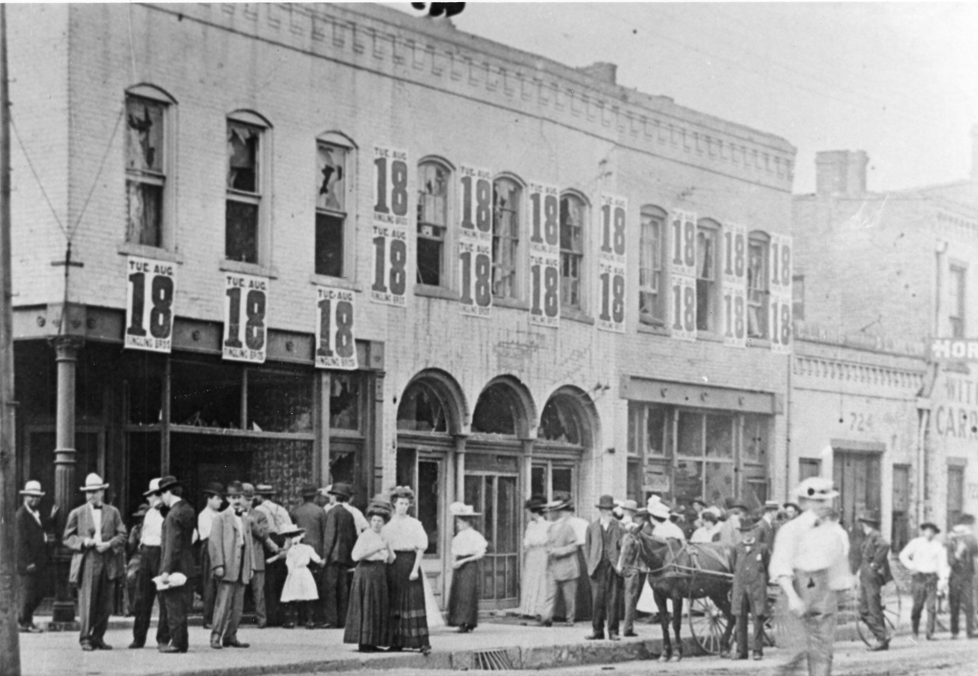 Black and white photographs of businesses with busted out windows and a crowd of white people gathered in the street.