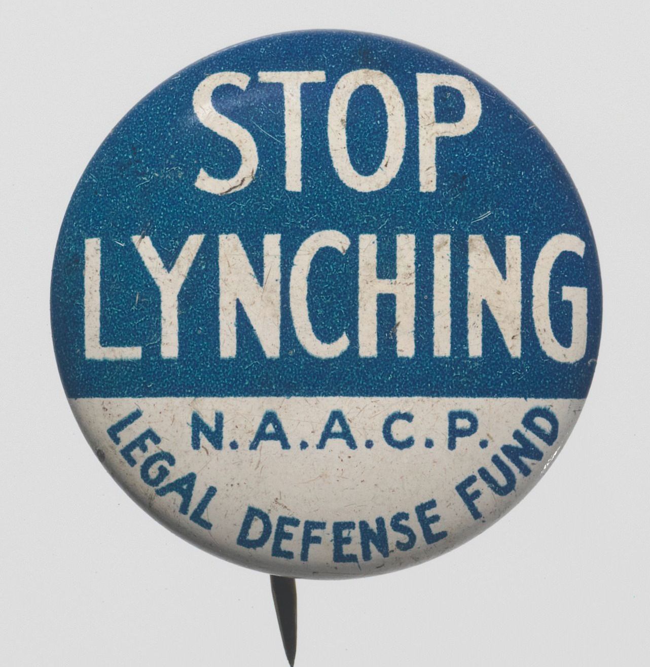 A blue and white circular pinback button. The top half reads