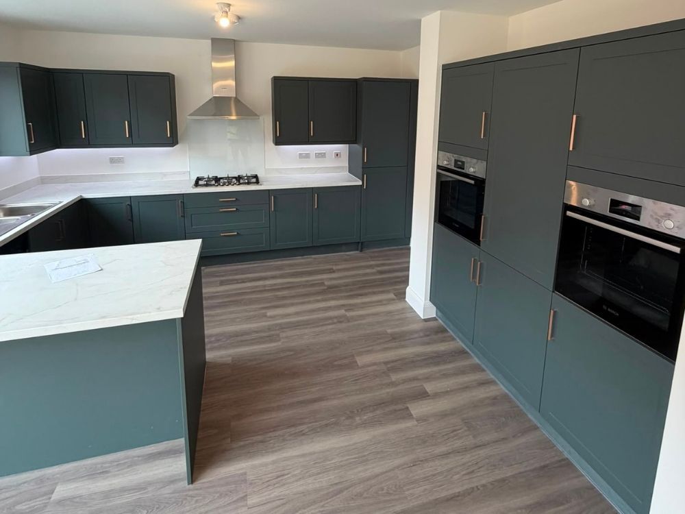 Navy shaker kitchen with island, quartz worktop and integrated appliances
