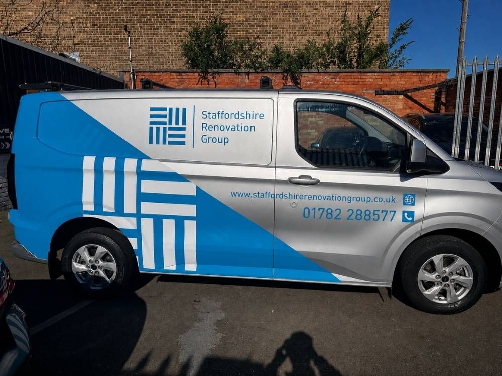 Staffordshire Renovation Group liveried van showing the company name and phone number